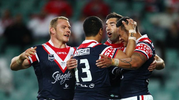 Flying start ... Roosters players celebrate the try scored by Joseph Leilua, right.