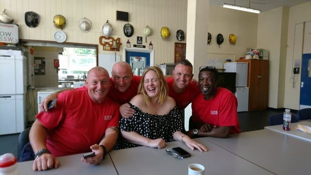 Spreading good cheer... Adele visits firefighters. 