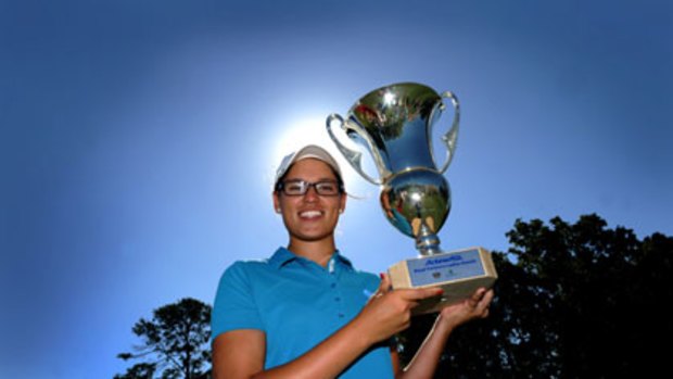 One for the scrapbook ... amateur Ashley Ona with the spoils of victory at the Royal Canberra Ladies Classic.