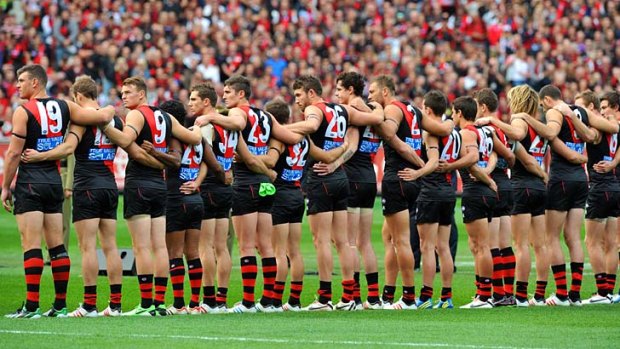 The Essendon players line up before this year's Anzac Day match.