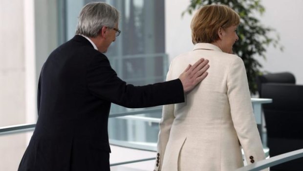 Mr Juncker and Mrs Merkel last year: She denied any "backroom deals" had been done over Mr Juncker's nomination.