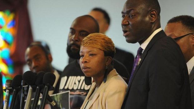 Lesley McSpadden, mother of Michael Brown, with Mr Brown's father, Michael snr (left) and their lawyer Benjamin Crump.