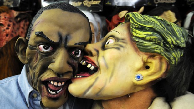 Halloween masks of Barack Obama and Hillary Clinton.