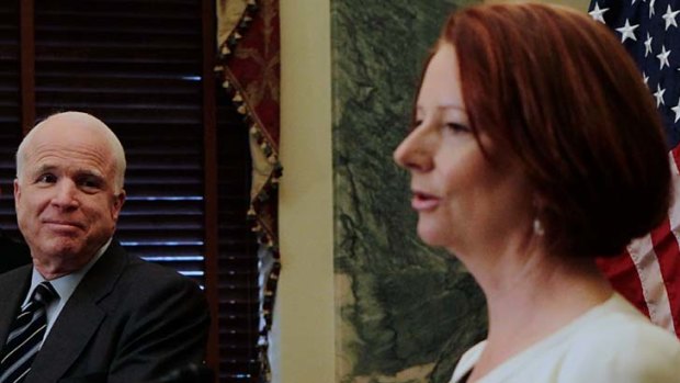 US Senator John McCain looks on as Australia Prime Minister Julia Gillard speaks.