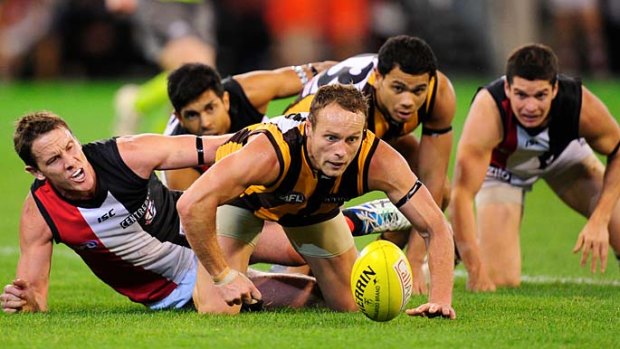 Before you walk: Hawthorn's Brad Sewell leads the crawl for the ball last night.