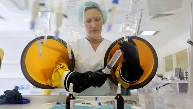 A dispensing chemist prepares drugs for a chemotherapy treatment in a sterile room at Antoine-Lacassagne Cancer Centre in Nice.