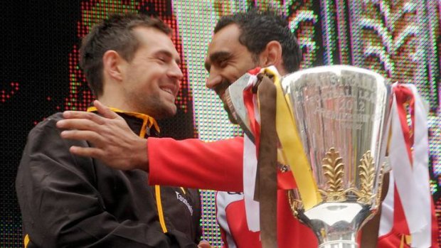 Grand final rivals: Luke Hodge with Adam Goodes yesterday.