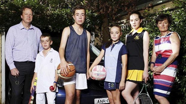 One, family, two destinations: Simon Rigby takes his sons Charlie, 10, and Nick, 14, to sport  ... while Caroline Rigby takes their daughters Annabel, 15, and Millie, 10.