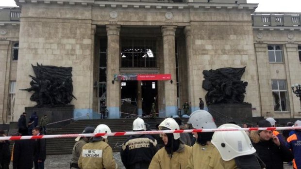 Aftermath: Russian firefighters and security personnel inspect the damage following the attack.