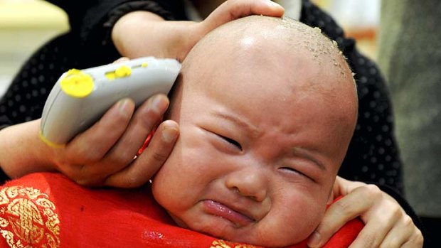 Stressed out ... a child gets a haircut in Hefei, Anhui province.
