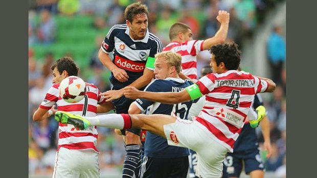 Men in the middle: Victory's Mitch Nichols and Mark Milligan compete with a host of Wanderers.