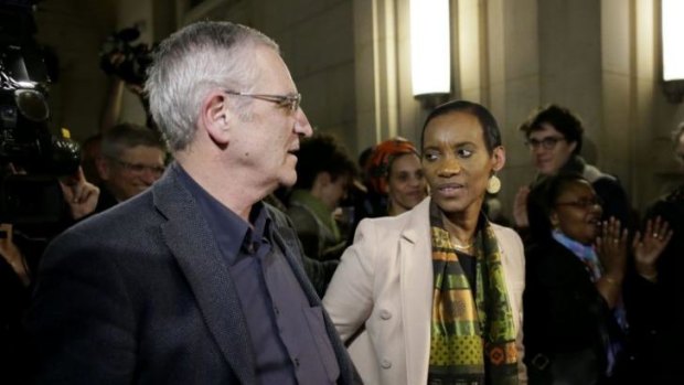 Rwandan genocide-hunters Alain Gauthier and his wife Dafroza leave the Paris courthouse after the guilty verdict.