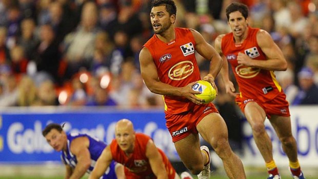 In the Hunt: Gold Coast's Karmichael Hunt charges clear during the Suns' seven-point loss to North Melbourne last night.
