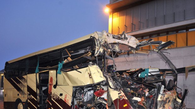 The wreckage of the bus after it collided with the wall of a motorway tunnel near Sierre in Switzerland.