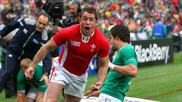 On the road to victory ... Shane Williams of Wales celebrates after scoring the opening try after two minutes.