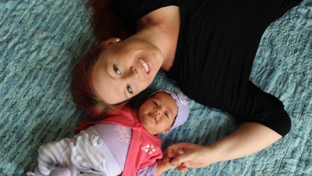 Melissa Murray with her seven-week-old daughter, Leilani, on her lounge room floor where she gave birth.