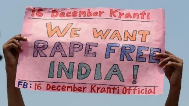 A protester holds up a sign promoting Indian anti-rape advocacy group 16 December Kranti.