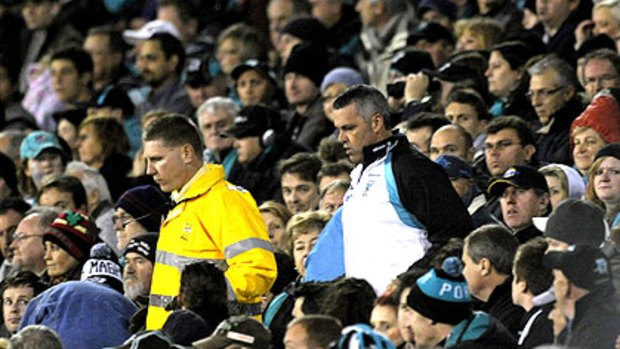 Just a face in the crowd, Port Adelaide coach Mark Williams heads on to the field at AAMI Stadium last night to address his team.