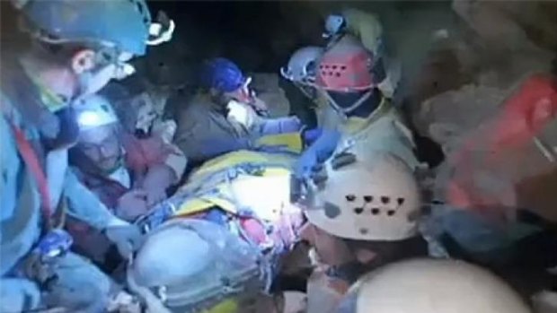 Helping hands: Rescuers assist Dr Westhauser inside the cave.