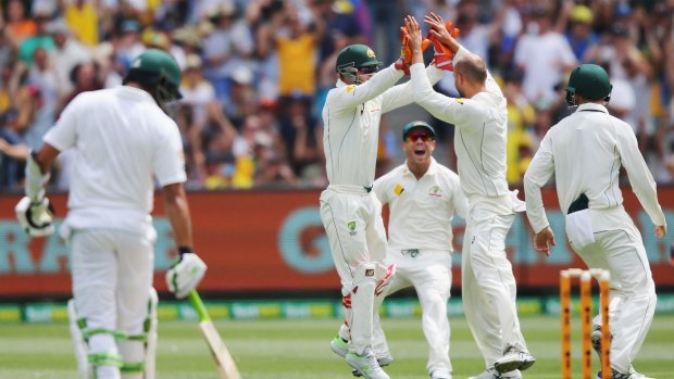 Australian players celebrate after Steve Smith of Australia catches out Sami Aslam off the bowling of Nathan Lyon.