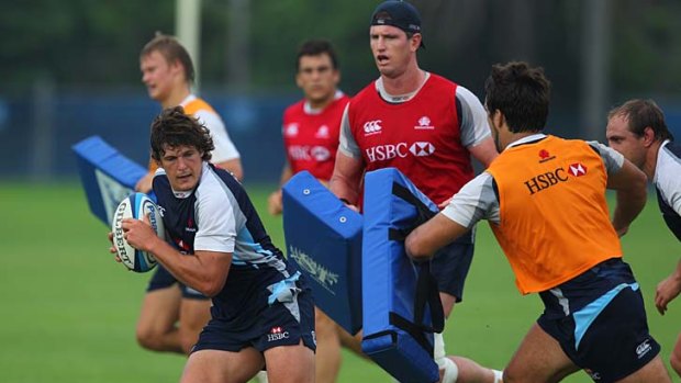 Breakout . . . Luke Burgess steps on the pace during Waratahs training at the SCG yesterday.