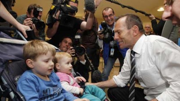 Opposition Leader Tony Abbott greets locals in the seat of Aston during a shopping centre visit in Knox City in Melbourne.