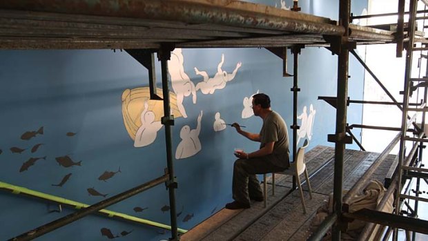 Revamp: Guan Wei installs his mural <em>The Journey to Australia</em> on the stairs of the Museum of Contemporary Art.