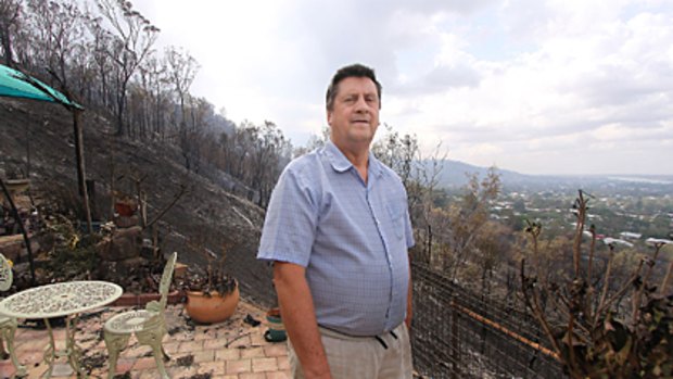 Devastation ... local Michael Dobson looks out from his patio at the damage left after the bushfire raced past his house.
