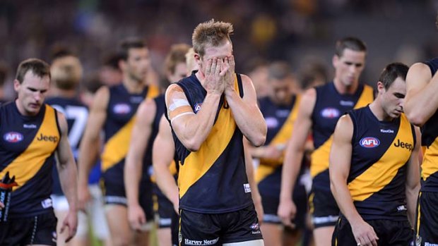 The dejected Richmond team leaves the ground after the 44-point loss to Carlton.