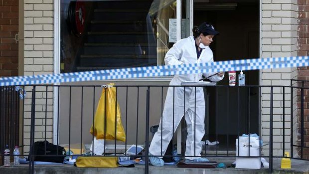 A forensics officer at work at the flats on Thursday.
