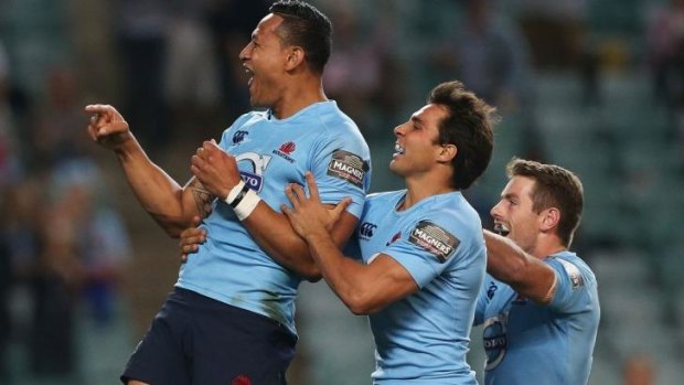 Israel Folau celebrates his early try for the Waratahs.