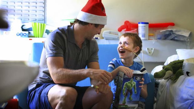 Lucas Neil delivers a present to five-year-old Riley Nixon.