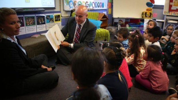 NSW Education Minister Adrian Piccoli poses with children at Condell Park Public School