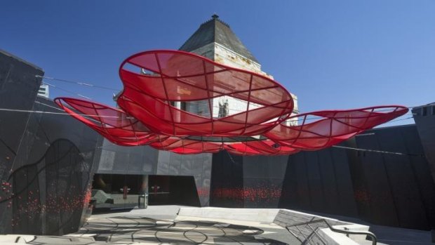 Stark: A large shade canopy in the form of a red poppy floats overhead in one of the new courtyards at Melbourne's Shrine of Remembrance, redeveloped by ARM Architecture.