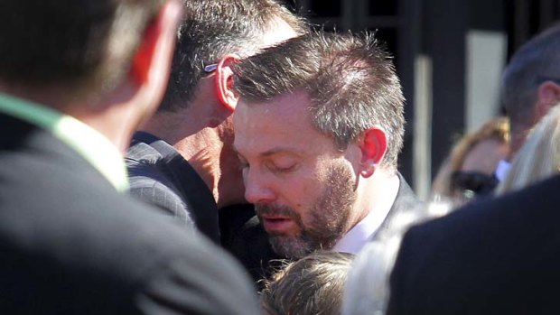 Gerard Baden-Clay is comforted by friends and family at the funeral of his slain wife, Allison, at St Paul's Anglican Church, Ipswich on May 11.