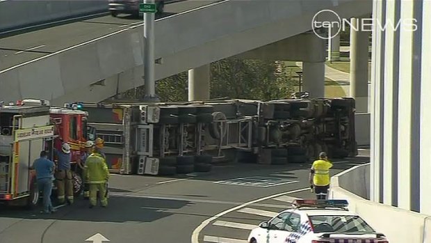 Emergency crews work to remove a truck that is causing traffic chaos in Brisbane.