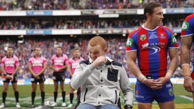 Overcome: Alex McKinnon brushes away a tear as he lines up with his Knights teammates before kick-off on Sunday.