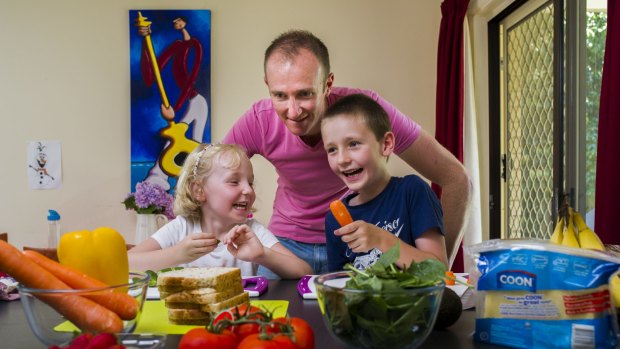 Neill Taylor with his children Imogen, 4, and Xavier, 7, making healthy sandwiches for lunch.