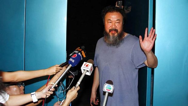 Dissident artist Ai Weiwei greets the media outside his Beijing studio after his release.