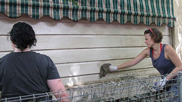 Volunteers rush to lend a hand to clean the Moore residence before they get home from holidays.