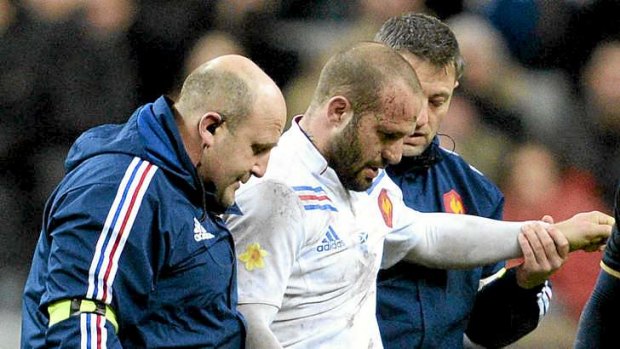 Frederic Michalak leaves the pitch after injuring his shoulder against Scotland.