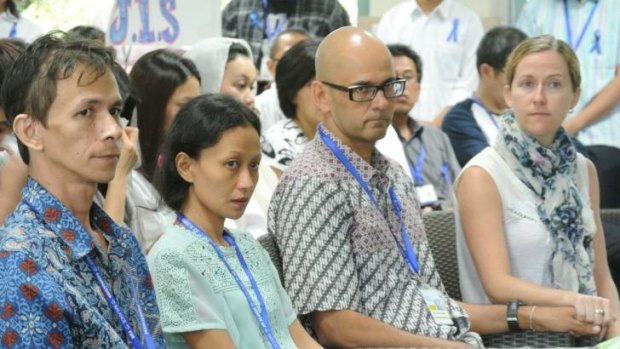 Two teachers held by Indonesian police without charge: Ferdinant Tjiong (left) with his wife, Fransisca, and Neil Bantleman, with his wife Tracey.