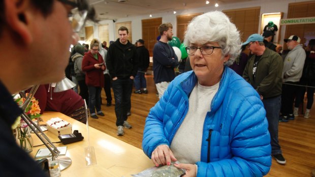 Margot Simpson becomes among the first people to buy marijuana at the Harborside dispensary in Oakland, California, on January 1.