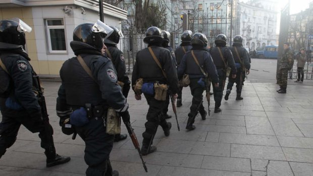 Riot police leave the Presidential office in Kiev.