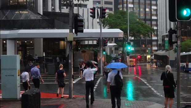 CBD workers rush to get out of the rain.