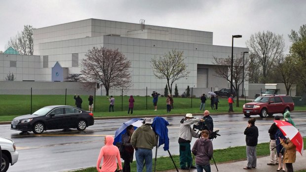 People stand outside Prince's Paisley Park compound in Chanhassen, Minn. Paisley Park, the private estate and production complex of the late rockstar, will open for public tours in October.