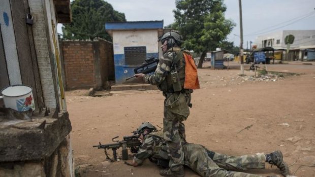 Grim day: French soldiers take fire position during a disarmament operation in Bangui on Monday. Photo: AFP