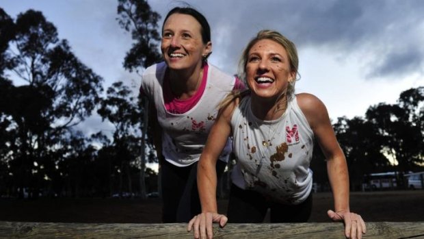 From left, Sharon Moloney of O'Connor and Rochelle Riley of Casey preparing for Miss Muddy, an obstacle course fitness event on at Exhibition Park in Canberra on October 19.