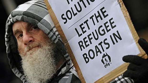 An activist from the Refugee Action Coalition holds a placard during a rally in Sydney .