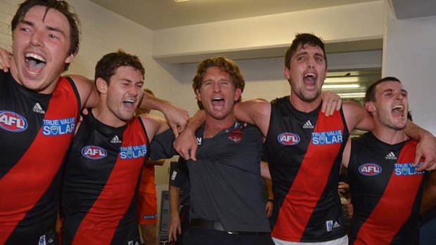 Our hero: Essendon players celebrate with coach James Hird after the stirring win on Friday night.
